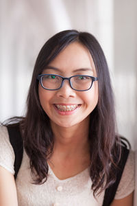 Close-up portrait of smiling young woman