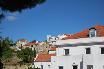 Low angle view of residential buildings against blue sky