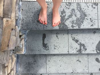 Low section of woman standing on steps