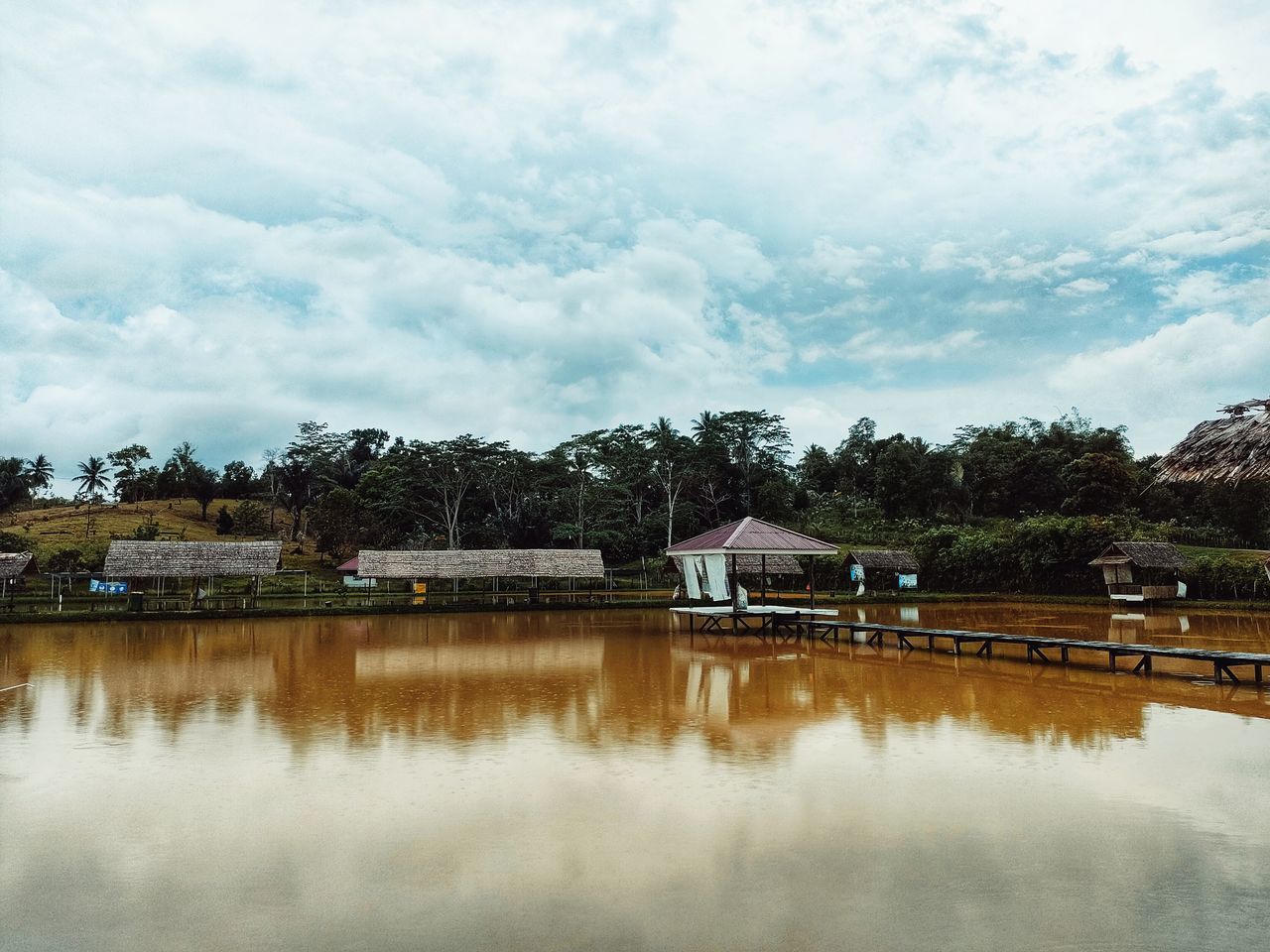 HOUSE BY LAKE AGAINST SKY