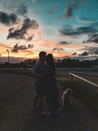 Woman with dog at sunset