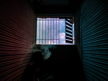 Rear view of woman in glass window