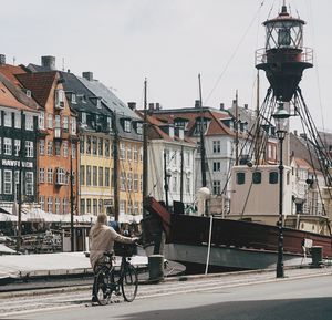 Horse cart in city against sky