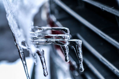 Close-up of icicles on metal during winter