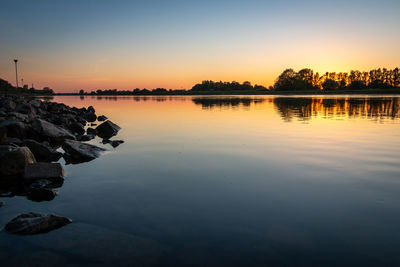 Scenic view of lake against sky during sunset