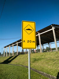 Road sign against sky