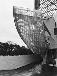 Low angle view of bridge over river against sky