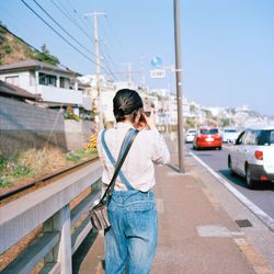 Full length of man standing in city against sky