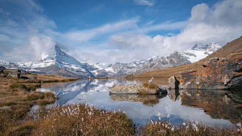 Scenic view of lake and mountains against sky