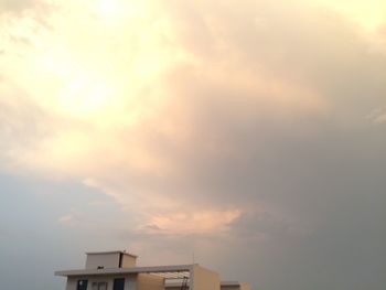 Low angle view of building against cloudy sky