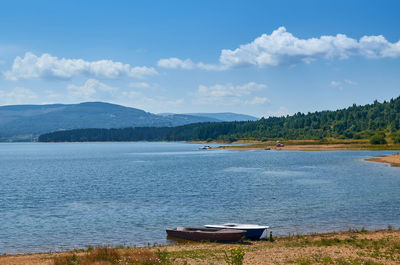 Boats on the vlasina lake with hills in a distance on a summer day