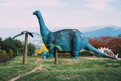 View of horse sculpture on field against sky