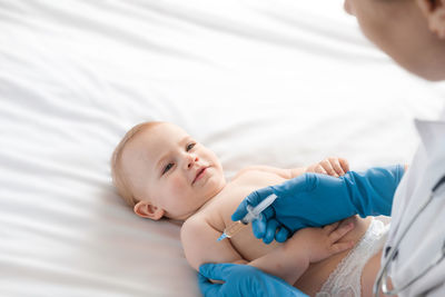 Doctor vaccinating newborn baby in clinic. little baby get an injection. vaccine for infant child. 