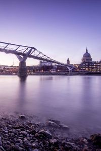 View of bridge over river at night