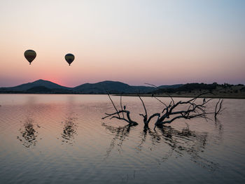 Scenic view of lake against sky during sunset