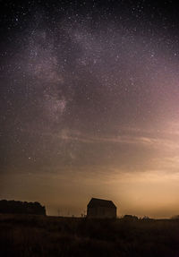 Scenic view of field against sky at night