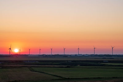 Scenic view of field against sky during sunset