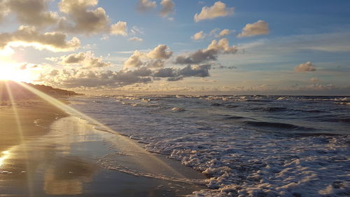 Scenic view of beach against sky during sunset