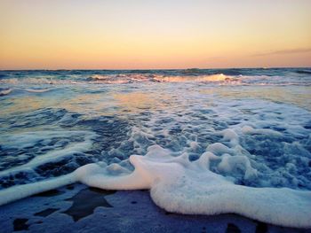 Scenic view of sea against clear sky during sunset