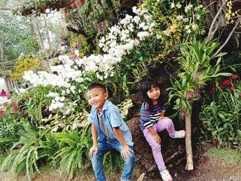 Full length of mother and daughter amidst plants