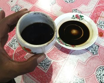 High angle view of woman holding coffee cup