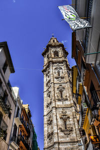 Low angle view of bell tower against blue sky