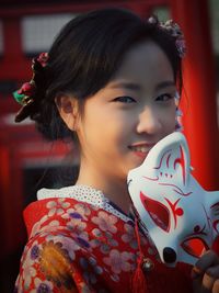 Smiling teenage girl wearing kimono outdoors