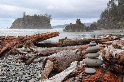 Rocks on beach against sky