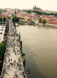 High angle view of people on charles bridge over vltava river