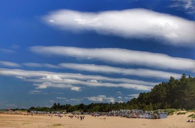 Scenic view of beach against cloudy sky