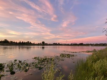 Scenic view of lake against sky at sunset