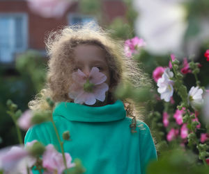 Portrait of woman with pink flower