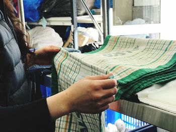 Midsection of woman holding textile 