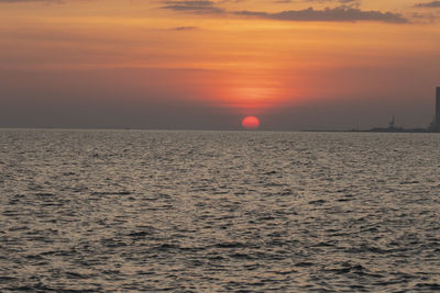 Scenic view of sea against orange sky