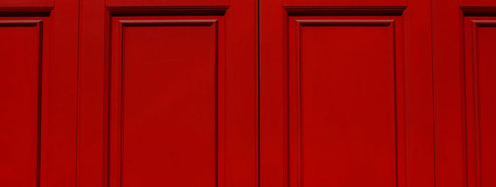 Portion of red lacquered wooden door.