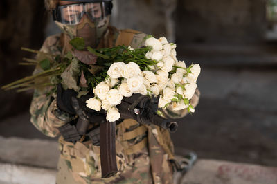 Midsection of woman holding bouquet