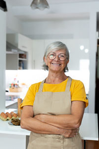 Portrait of young woman standing at home