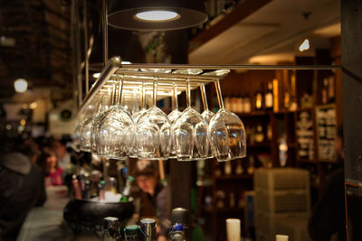 Illuminated pendant lights hanging in store at restaurant