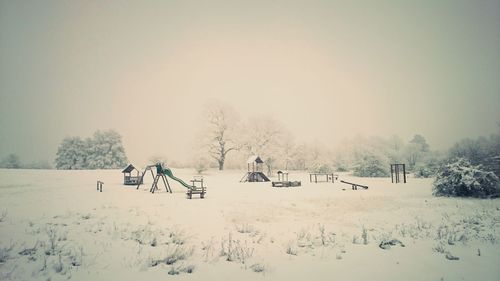 Scenic view of field against clear sky during winter