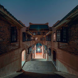 Alley amidst buildings against sky in city