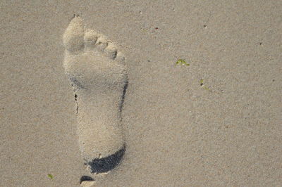 High angle view of footprints on sand
