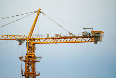 Low angle view of crane against clear sky