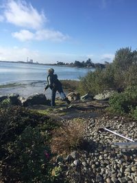 Full length of woman standing on shore