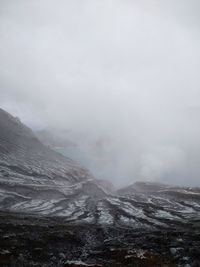 Scenic view of the sulphuric volcano crater against the fog