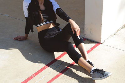 Low section of woman sitting on floor