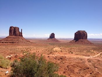 Scenic view of desert against clear blue sky