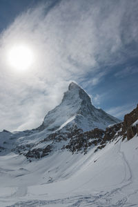 Scenic view of snow covered mountains against sky