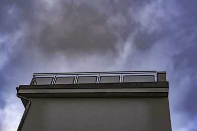 Low angle view of old building against cloudy sky