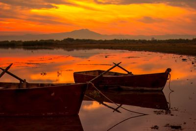 Boats in lakes at sunset