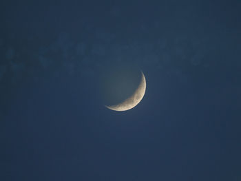 Low angle view of half moon against sky at night